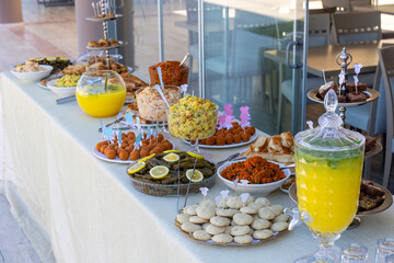 Outdoor catering buffet with a variety of food snacks and appetizers