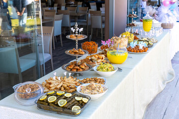 Outdoor catering buffet with a variety of food snacks and appetizers