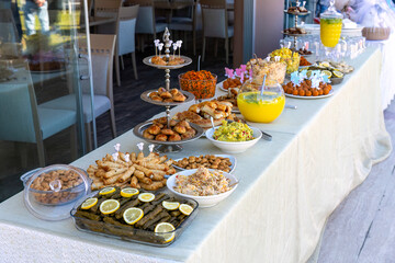 Outdoor catering buffet with a variety of food snacks and appetizers