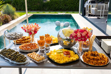 Outdoor catering buffet with a variety of food snacks and appetizers