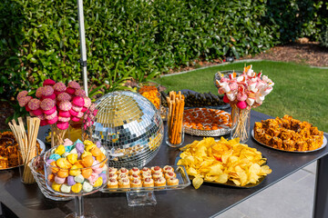 Outdoor catering buffet with a variety of food snacks and appetizers