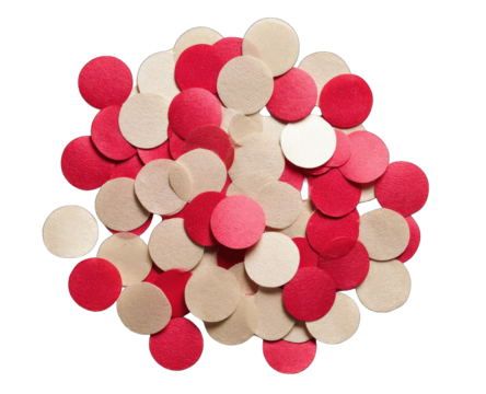 A cluster of small, circular, red and cream-colored confetti pieces, densely packed