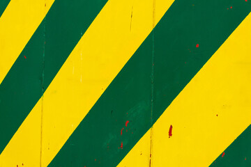 Yellow and green sheet metal background with transverse stripes