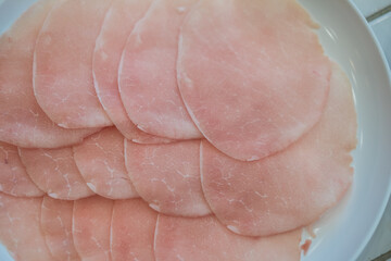 Pork slice, sliced thinly served on white dish for cooking in pot of boiling water, hot pot, hot pan