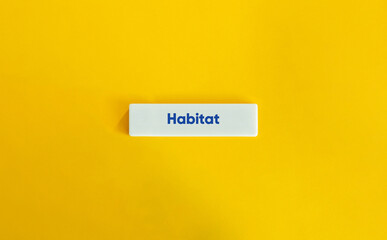 Habitat Word on Letter Tile on Yellow Background – Minimalist Concept of Home and Environment
