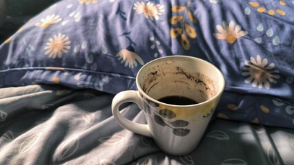 Used Mug with Coffee Sediment on Bedding. Relaxing Your Morning. Start with Positive Moods