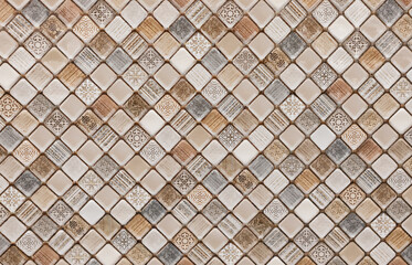 Colorful mosaic tile pattern showcasing geometric designs in shades of beige, brown, and gray ideal for home decorating or interior design projects