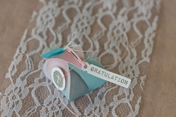 Lovingly wrapped small gift package for confirmation with ribbon and lettering GRATULATION