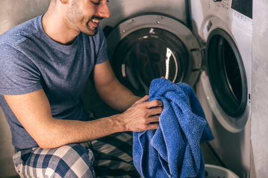 Man Doing Laundry - Powered by Adobe
