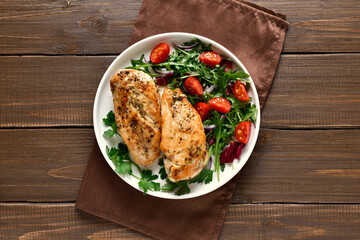 Roasted chicken breast and vegetable salad on plate