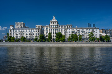 Moscow. Russia. May 24, 2025. The house of oil workers on Taras Shevchenko Embankment, built in 1952, Moscow River on a sunny day.