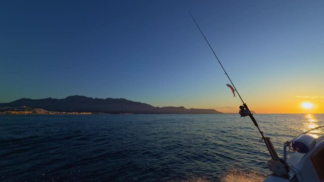 Fishing rod and reel lure at sunrise in Altea Mediterranean sea