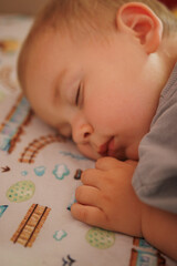little boy sleeping in his crib close up