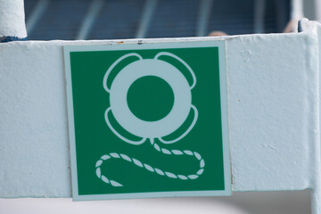 Red life buoy hanging on a blue wall. Help and support concept.