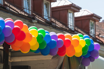 Rainbow coloured balloons on a truck during a LGBT+ pride parade