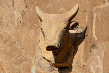 Ancient bull head relief carved in stone on a church facade in Mtskheta, Georgia. 