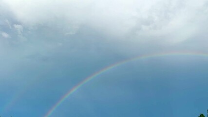 a rainbow in the sky after the rain - Powered by Adobe