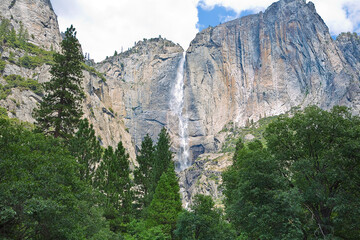 Scenic panoramic view of famous Yosemite Valley with waterfall -