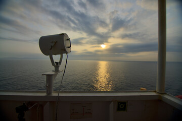 View from the bridge wings of a ship at sea in the early morning