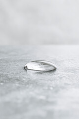 macro shot of single water droplet on matte metal surface highlighting its intricate details and reflections