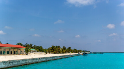 Buildings and boats line island shore.