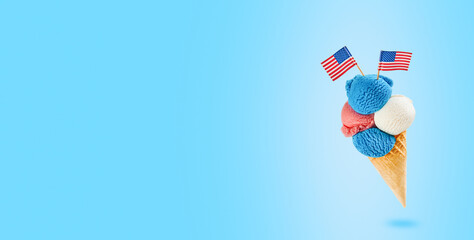 4th of July Holiday background. Colorful ice cream cone with red, white and blue scoops patriotic colors flavors flying in air on blue background. Happy Independence Day concept. Mock up.