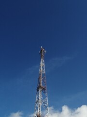 Obraz premium Telecommunication tower with clear blue sky.