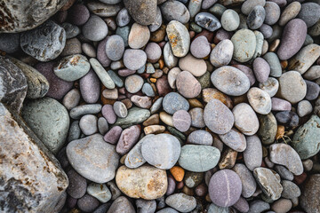 close up of colorful pebbles on the beach, natural pattern