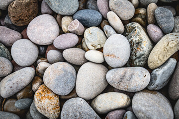 close up of colorful pebbles on the beach, natural pattern