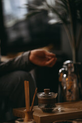 A cozy tea ceremony setting with glass teacups, wooden tray, and warm lighting. Calm atmosphere, mindfulness, and traditional tea preparation in a modern interior.