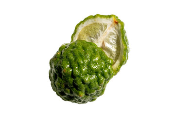 Fresh kaffir lime whole and cut in half, rough green rind and juicy pulp, isolated on white background