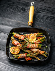 Grilled Bacon Wrapped Asparagus in iron cast pan