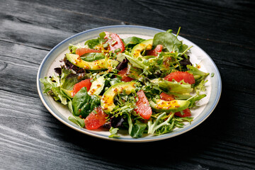 Fresh salad with grapefruit, avocado and mustard, honey dressing