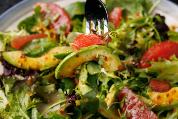 Fresh salad with grapefruit, avocado and pomegranate seeds