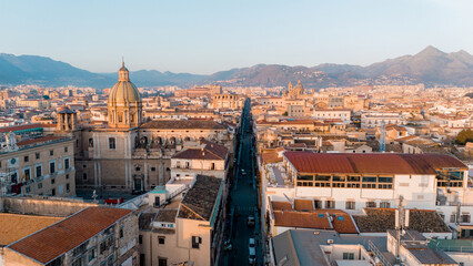 Aerial panorama of Palermo, Sicily, revealing the city's dense historic core, domes, and terracotta...