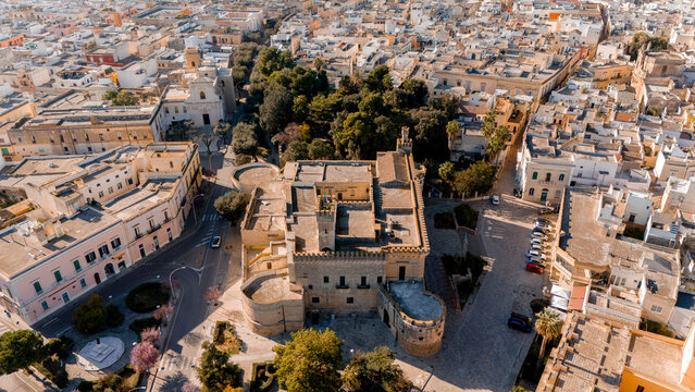 Aerial view of the baroque heart of Nardo, Italy, during golden hour. The cathedral and white rooftops glow in warm light, revealing the towns intricate historic layout