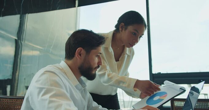 Coworkers analyze chart and collaborate