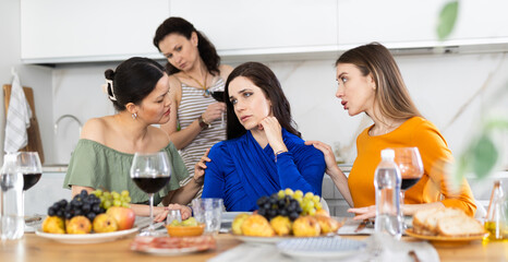 Woman shares her problems with her friends. They calm her down