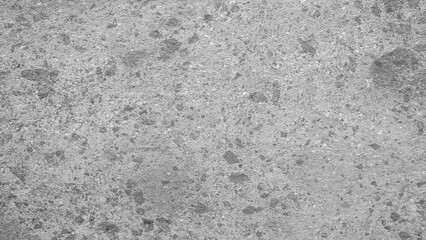 A grey and white background with a few small dots scattered throughout. The background is a solid grey color, while the dots are small and white. The overall effect is a simple and minimalistic look