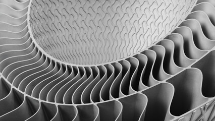 complex metal piece with a pattern created by a 3D printer. The lines are arranged in a spiral pattern, creating a sense of movement and energy. Adaptive technologies concept background