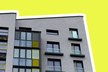 Building corner with modern apartment architecture. Yellow facade with geometric windows and