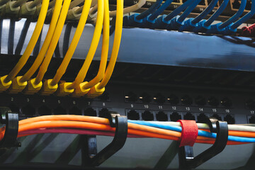 multi-colored fiber optic wires inserted into electronic switching unit, industrial internet...