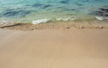 Beach sand with tropical blue sea waves