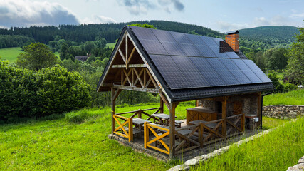 Summer gazebo with solar panels in the mountains on a clear day in summer