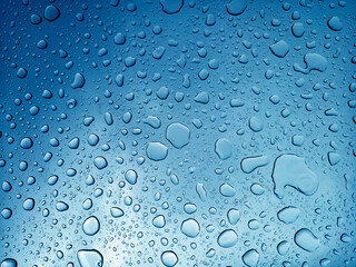 The water drops resting upon a smooth surface showcasing their beauty and details