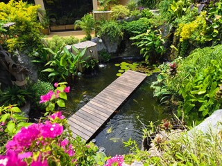 Serene pond complete with a beautiful waterfall and fish swimming gracefully