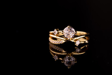 Gold ring with diamonds, isolated on black background