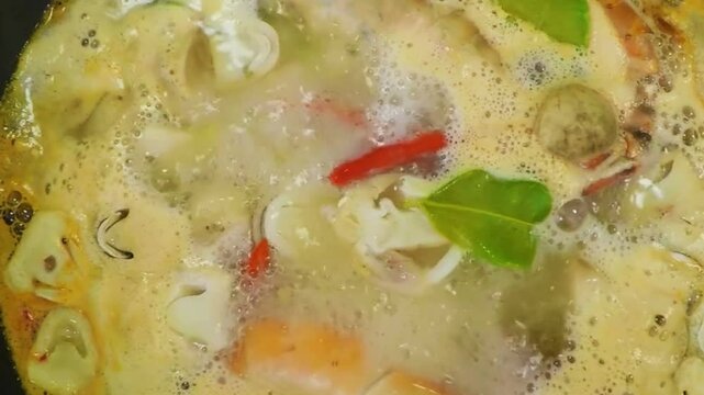 Creamy Coconut Milk Soup with Chicken and Vegetables Simmering