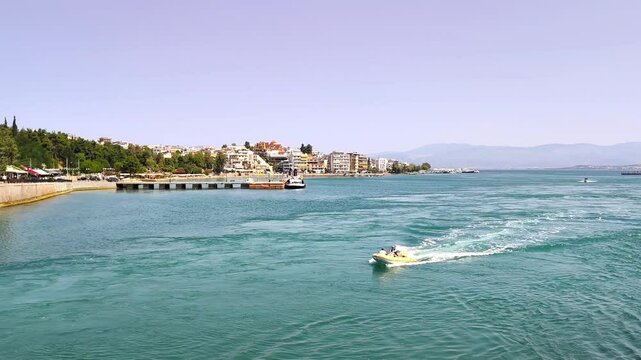 View of a speedboat crossing the Euripus strait in Chalkis, Euboea, cutting through the famously shifting &ldquo;crazy currents&rdquo; .