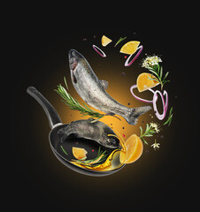 Sea trout with rosemary branches and lemon falling into frying pan on black background